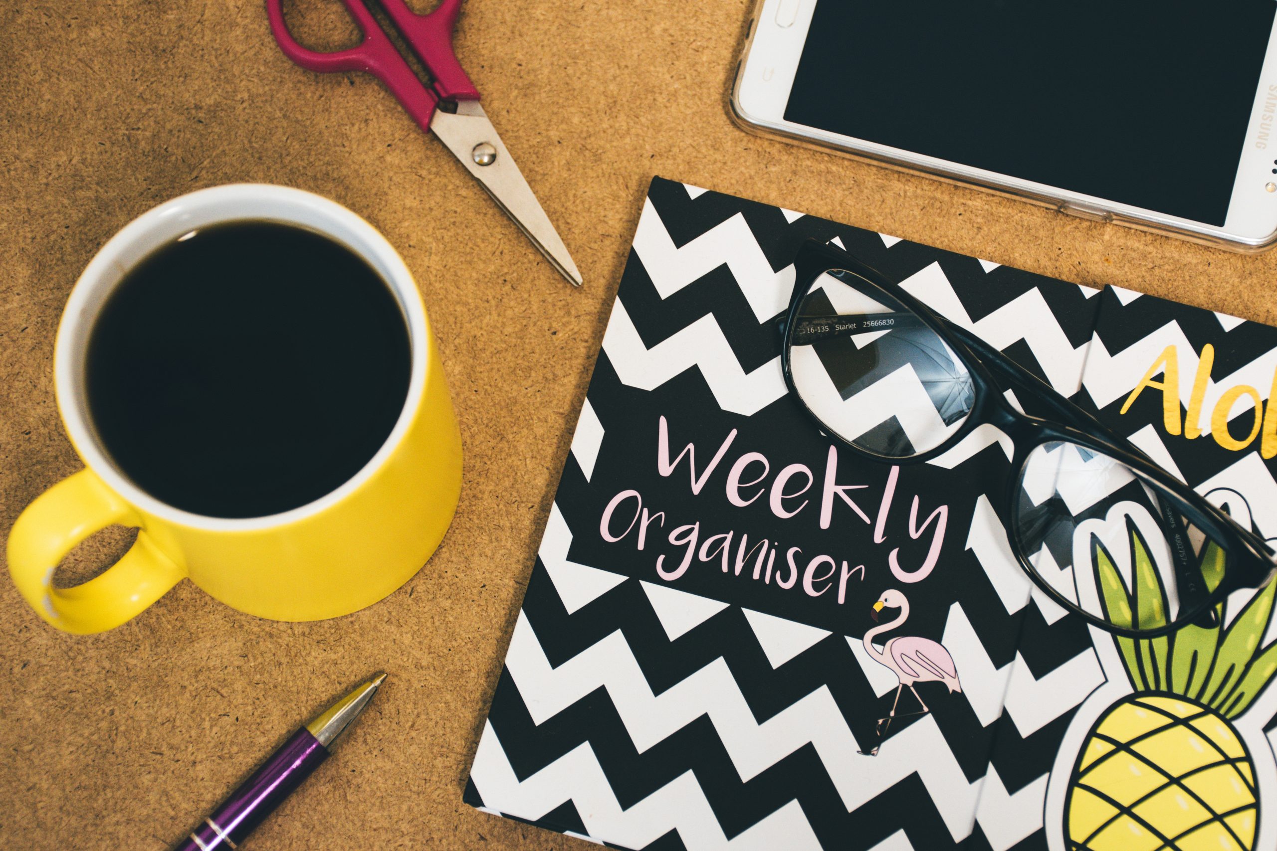 weekly organiser notebook with coffee